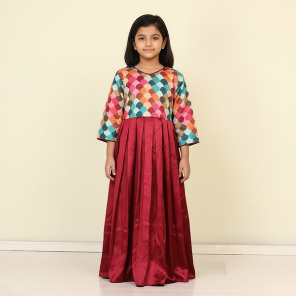 A VIBRANT FROCK WITH MULTICOLORED SCALLOPED TOP WITH A RICH MAROON PLEATED SKIRT