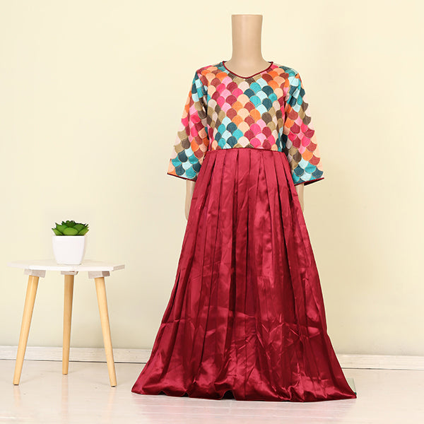 A VIBRANT FROCK WITH MULTICOLORED SCALLOPED TOP WITH A RICH MAROON PLEATED SKIRT